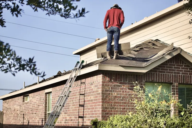Professional roofer working on a residential roof in Timonium